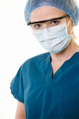 shield business - Face of a woman doctor wearing protective hair net and face mask and eye shield for protection on white Stock Photo - Budget Royalty-Free & Subscription, Code: 400-04499978
