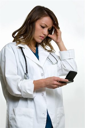 pager - Woman doctor in wearing a doctors lab coat holding up  an open pager with hand on head showing a worried expression Stock Photo - Budget Royalty-Free & Subscription, Code: 400-04499981