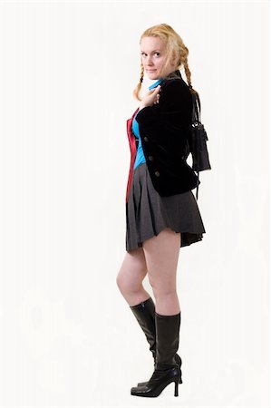 Full body of an attractive woman with hair in braids wearing school girl outfit and long black boots standing Stockbilder - Microstock & Abonnement, Bildnummer: 400-04499994
