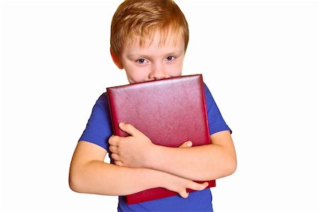 simsearch:400-08429355,k - Young boy holding a book isolated on white Photographie de stock - Aubaine LD & Abonnement, Code: 400-04490051