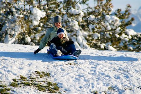 simsearch:400-04449607,k - Mother and Son Sledding down the Hill - Winter Scenes Photographie de stock - Aubaine LD & Abonnement, Code: 400-04490382