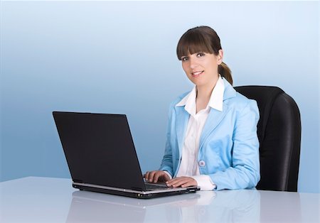 simsearch:400-08554629,k - Satisfied businesswoman working with a laptop on a blue background Fotografie stock - Microstock e Abbonamento, Codice: 400-04490442