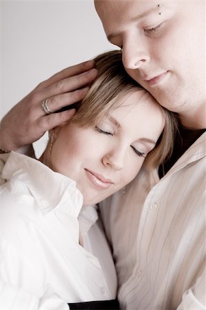 simsearch:400-03969572,k - Studio portrait of a young amorous couple relaxing Fotografie stock - Microstock e Abbonamento, Codice: 400-04490626