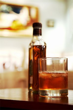 Glass of whisky with an ice on a table at restaurant Stock Photo - Budget Royalty-Free & Subscription, Code: 400-04490646