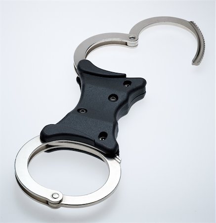simsearch:400-04300810,k - Standard issue rigid bar handcuffs Photographie de stock - Aubaine LD & Abonnement, Code: 400-04491178
