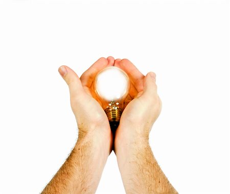 A concept image of a new idea, new birth.  A light bulb being gently held in a pair of mens hands, while the light bulb is glowing Stock Photo - Budget Royalty-Free & Subscription, Code: 400-04491369
