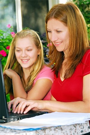 Mother and daughter working on computer at home in the backyard Photographie de stock - Aubaine LD & Abonnement, Code: 400-04492823