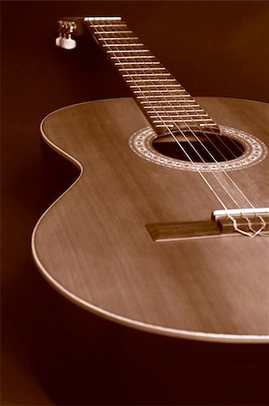 Closeup of a duotone (brown and orange) guitar to create a sepia picture. Nice DOF with a focus point at the middle circle. Fotografie stock - Microstock e Abbonamento, Codice: 400-04493320