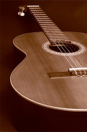 simsearch:400-07301387,k - Closeup of a duotone (brown and orange) guitar to create a sepia picture. Nice DOF with a focus point at the middle circle. Foto de stock - Super Valor sin royalties y Suscripción, Código: 400-04493320