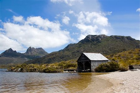 simsearch:400-04493526,k - An old boathouse rests by the calm lakeside at Cradle Mountain in Australia's wild state of Tasmania. Stock Photo - Budget Royalty-Free & Subscription, Code: 400-04493523