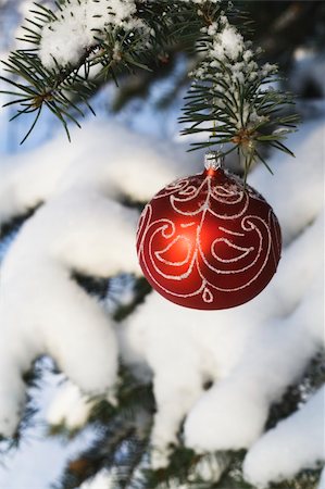 round ornament hanging of a tree - Cristmas tree decoration handing on fir tree covered with snow Stock Photo - Budget Royalty-Free & Subscription, Code: 400-04493704