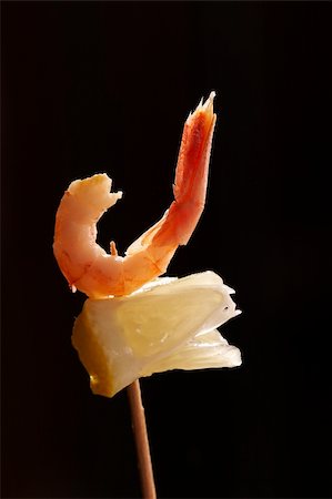 shrimp black - appetizing snack: freshly cooked prawn on the stick with lemon over black background Stock Photo - Budget Royalty-Free & Subscription, Code: 400-04493998