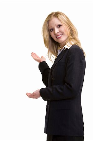 female black real estate agent - Attractive blonde woman in professional business suit standing sideways holding up hand as in showing something behind her standing on white Foto de stock - Super Valor sin royalties y Suscripción, Código: 400-04504154