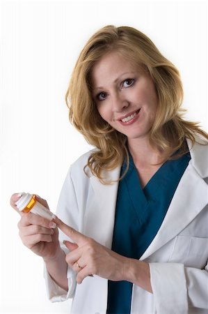 Attractive blonde lady pharmacist or doctor holding and pointing to a white medication bottle smiling standing on white Stock Photo - Budget Royalty-Free & Subscription, Code: 400-04504181