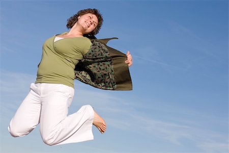 fat jump - voluptuous woman jumping in the sky, happy because spring is coming Stock Photo - Budget Royalty-Free & Subscription, Code: 400-04504524