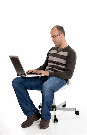 simsearch:400-04963726,k - Buziness man seated on chair and working on a laptop Stock Photo - Budget Royalty-Free & Subscription, Code: 400-04505065