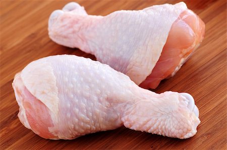 raw chicken on cutting board - Raw chicken drumsticks on a wooden board Stock Photo - Budget Royalty-Free & Subscription, Code: 400-04505586