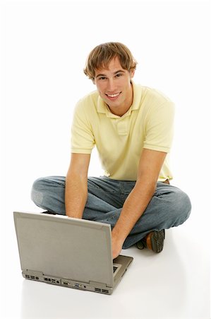school boy sitting cross legged - Handsome late teen man on a laptop computer.  Full body isolated on white. Stock Photo - Budget Royalty-Free & Subscription, Code: 400-04505682
