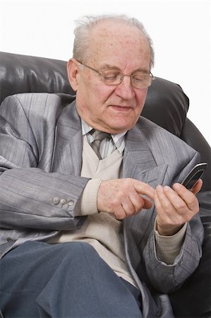 Close-up image of a senior man typing a message on his mobile phone.Shot with Canon 70-200mm f/2.8L IS USM Stock Photo - Budget Royalty-Free & Subscription, Code: 400-04506960