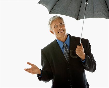 simsearch:400-04186486,k - Caucasian middle aged businessman holding umbrella and gesturing. Stock Photo - Budget Royalty-Free & Subscription, Code: 400-04507136