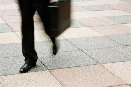 Motion blur of businessman legs walking outdoors with briefcase. Stock Photo - Budget Royalty-Free & Subscription, Code: 400-04507145