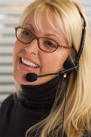 simsearch:400-04001946,k - Attractive businesswoman talks on her phone headset. Foto de stock - Super Valor sin royalties y Suscripción, Código: 400-04507387