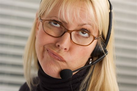simsearch:400-05098432,k - Goofy businesswoman talks on her phone headset. Photographie de stock - Aubaine LD & Abonnement, Code: 400-04507389