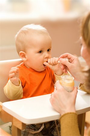 fat family eating pic - Feeding procedure of a little baby boy - he attempts to take control Stock Photo - Budget Royalty-Free & Subscription, Code: 400-04507459