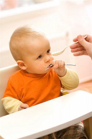 fat family eating pic - Feeding procedure of a little baby boy - he uses an extra spoon Stock Photo - Budget Royalty-Free & Subscription, Code: 400-04507460