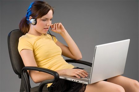 simsearch:400-04504422,k - pretty girl with the laptop on her legs talking with her microphone Photographie de stock - Aubaine LD & Abonnement, Code: 400-04507477