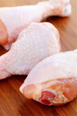 raw chicken on cutting board - Raw chicken drumsticks on a wooden cutting board Stock Photo - Budget Royalty-Free & Subscription, Code: 400-04507584
