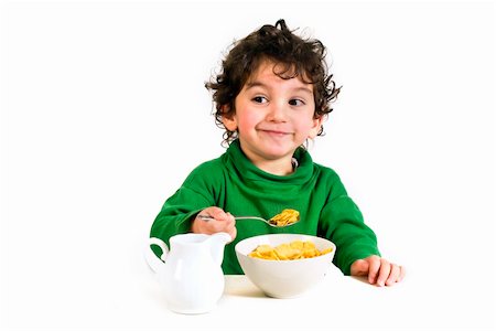 young boy eating cornflakes isolated on white Stock Photo - Budget Royalty-Free & Subscription, Code: 400-04507950