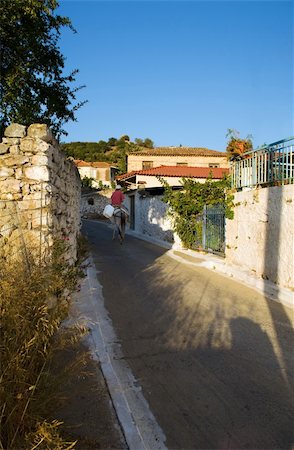 simsearch:400-04718145,k - The image illustrates the quite and peaceful life of a typical village in southern Greece. A lone donkey rider is moving up the narrow path. Photographie de stock - Aubaine LD & Abonnement, Code: 400-04508347