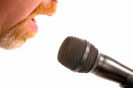 Bearded man speaking into a microphone with only cheeks and mouth visible. Isolated on white background. Stock Photo - Budget Royalty-Free & Subscription, Code: 400-04508750
