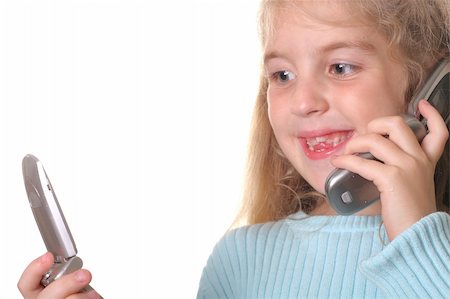 simsearch:400-06517383,k - happy young girl talking on a cell phone looking at another phone Fotografie stock - Microstock e Abbonamento, Codice: 400-04509574