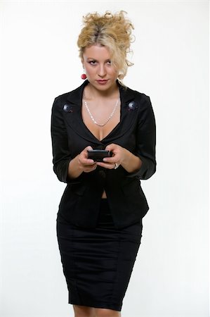 pager - Attractive blond young sexy business woman wearing business suit holding and typing on a pager Stock Photo - Budget Royalty-Free & Subscription, Code: 400-04500235