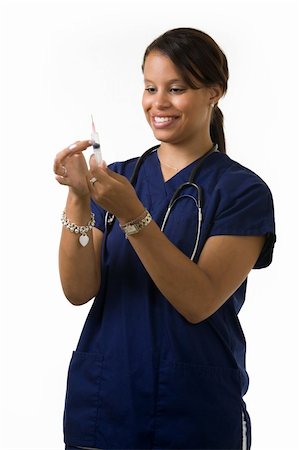 simsearch:400-03995908,k - Young attractive African American  woman healthcare worker wearing dark blue scrubs and a stethoscope holding and looking at a syringe with a friendly smile Stock Photo - Budget Royalty-Free & Subscription, Code: 400-04500272
