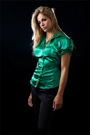 beautiful young woman with blond hair wearing shiny green satin blouse posing on black background Stock Photo - Budget Royalty-Free & Subscription, Code: 400-04500295