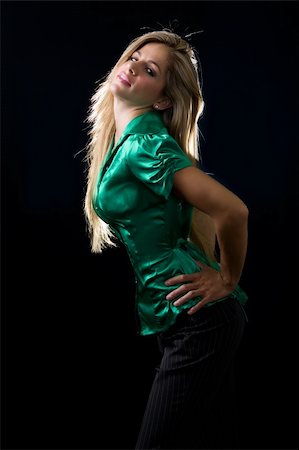 beautiful young woman with blond hair wearing shiny green satin blouse posing on black background Stock Photo - Budget Royalty-Free & Subscription, Code: 400-04500296