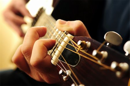 Hands of a person playing an acoustic guitar close up Stock Photo - Budget Royalty-Free & Subscription, Code: 400-04500606