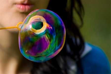 Young person creating a big soap bubble. Stock Photo - Budget Royalty-Free & Subscription, Code: 400-04500886