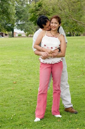 Asian man and woman standing on the grass in the park being affectionate Photographie de stock - Aubaine LD & Abonnement, Code: 400-04501167