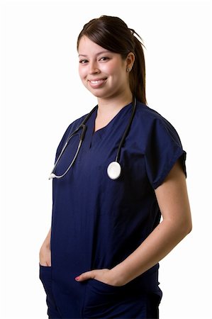 simsearch:400-05172792,k - Confident Hispanic woman healthcare worker wearing dark blue scrubs wearing a stethoscope standing on white Foto de stock - Royalty-Free Super Valor e Assinatura, Número: 400-04501178