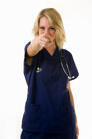 simsearch:400-05172792,k - Young pretty woman healthcare worker wearing blue scrubs and a stethoscope pointing finger Foto de stock - Royalty-Free Super Valor e Assinatura, Número: 400-04501288