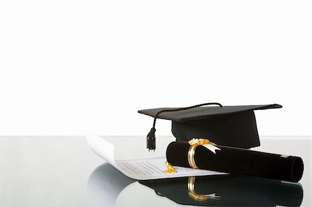 Arranging my graduation thing on the desk against white background Stockbilder - Microstock & Abonnement, Bildnummer: 400-04501525