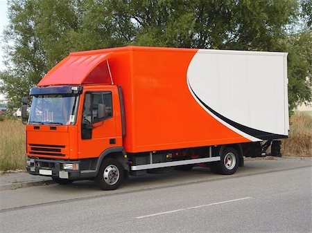 This is a picture of an orange and white, European delivery truck ready to deliver its goods. Stock Photo - Budget Royalty-Free & Subscription, Code: 400-04501583