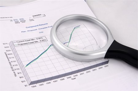 Financial investments chart showing proposed growth in assets. Magnifying glass sits on top. Stockbilder - Microstock & Abonnement, Bildnummer: 400-04501757