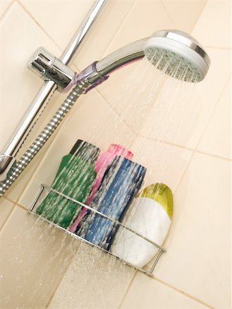 Showerhead in the bathroom with different color bottles Stock Photo - Budget Royalty-Free & Subscription, Code: 400-04502312