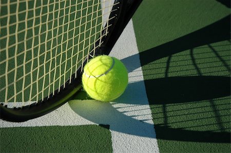 Shot of a tennis racket and ball in the shadow near to the T Fotografie stock - Microstock e Abbonamento, Codice: 400-04502847