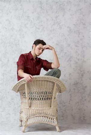 Male model posed in a wicker chair Foto de stock - Royalty-Free Super Valor e Assinatura, Número: 400-04502973
